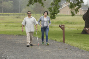 Instructor and client walking with cane