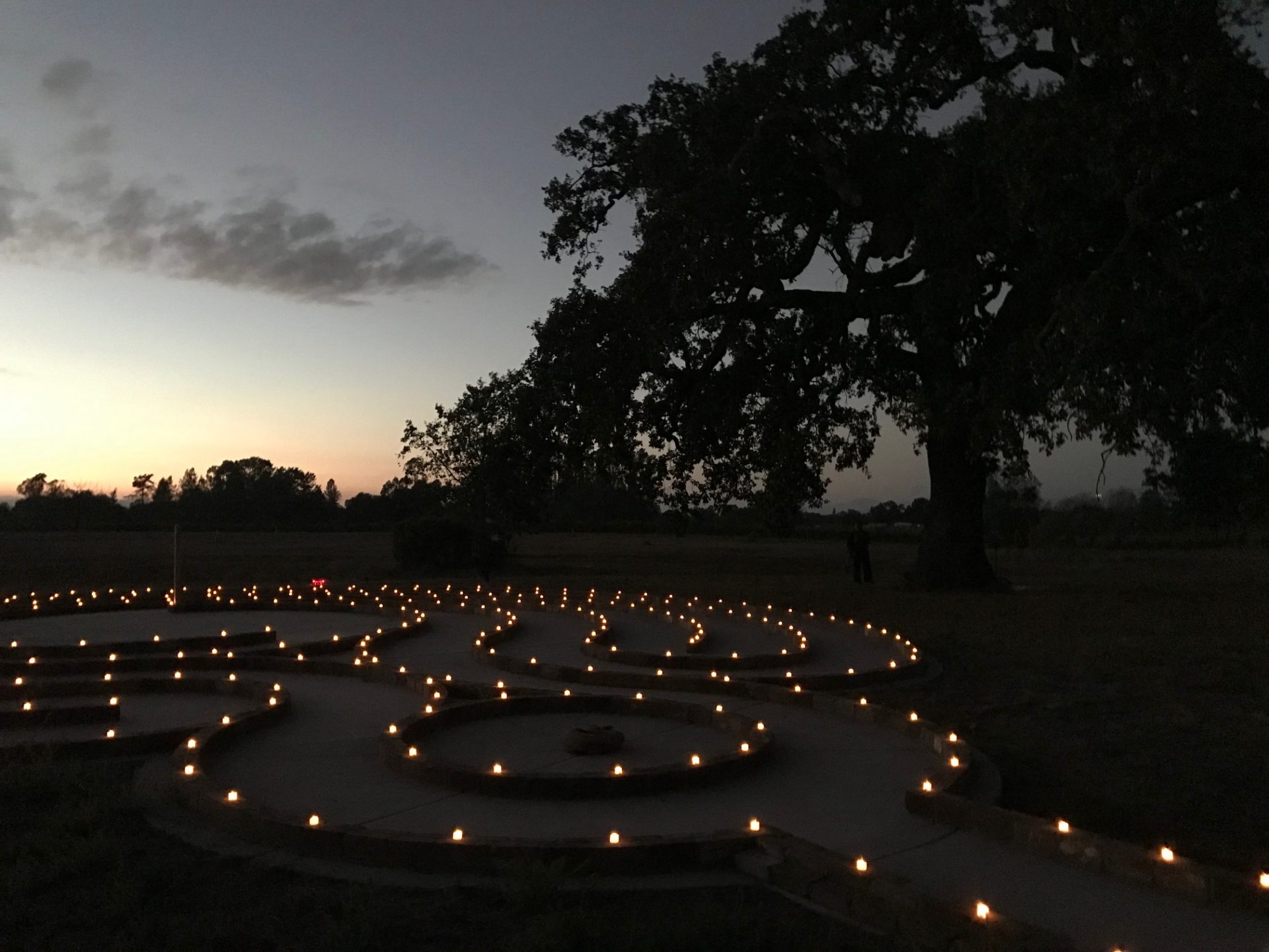 labyrinth at sunset outlined with votive candles